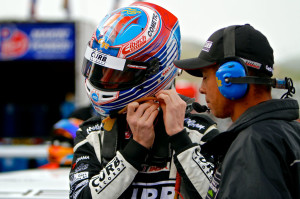 Michael Lewis straps on his helmet before climbing in to the No. 98 Competition Motorsports/Curb-Agajanian Porsche 911 GT3 Cup car on Sunday, May 4. Photo by Blake Blakely.