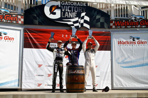 Earning his third podium of the 2014 IMSA GT3 Cup Challenge USA by Yokohama race season, Michael Lewis (left) holds his trophy proudly for his third-place finish during the weekend's Race 1 on Friday, June 27, at Watkins Glen International.