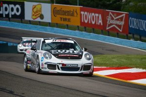 The No. 98 Competition Motorsports/Curb-Agajanian Porsche 911 driven by Michael Lewis hugs a turn at Watkins Glen International, in New York.