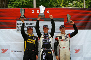 Michael Lewis shows off the trophy for taking the top spot on the podium for Round 12 of the IMSA Porsche GT3 Cup Challenge USA at Road America on Sunday, August 10.