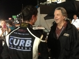 Mike Curb, on right, owner of Curb Records, and supporter and sponsor of Michael Lewis, speaks to Michael after Michael's strong performance in Friday's Race 2.