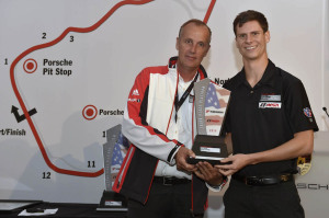 Michael Lewis receives a trophy for finishing third this season in the IMSA Porsche GT3 Cup Challenge USA by Yokohama from Eric Bloss, special projects manager at Porsche Motorsport North America.