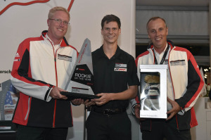 Michael Lewis earned Rookie of the Year honors this season after claiming four wins, six pole positions and nine podium appearances. Here, he accepts the award from Porsche Motorsport North America's Ralph Hollack (left) and Eric Bloss (right).