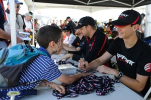 Michael Lewis enjoys interacting with fans, and he gladly offers his autograph to this young fan at Canadian Tire Motorsport Park.