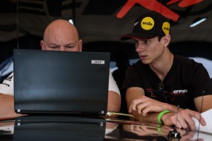 Andrew Gregory, of Porsche Motorsport North America, and Michael Lewis study the telemetry of the new Porsche 911 GT3 R.