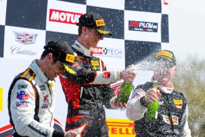 Celebrating his first GT win, Michael Lewis sprays the champagne on top of the PWC podium on Saturday, March 12, 2016.