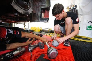 Michael Lewis stays busy both on and off the track during race weekends. Here, he helps an EFFORT Racing team member who is working on the No. 41 EFFORT Racing/Curb-Agajanian Porsche 911 GT3 R.