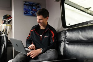 Even while off the track during race weekends, Michael Lewis stays busy with a variety of tasks, including examining data from the No. 41 EFFORT Racing Porsche 911 GT3 R. Photo by Camden Thrasher.