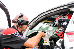 Michael Lewis prepares to qualify the No. 41 EFFORT Racing/Curb-Agajanian Porsche 911 GT3 R on Friday, June 26, as he receives a fist bump from EFFORT Racing crew member Paul Ashworth.