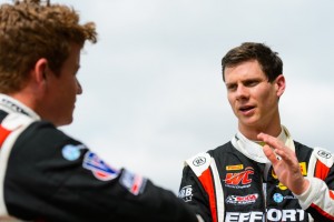 Michael Lewis discusses race strategy with EFFORT Racing teammate Patrick Long.